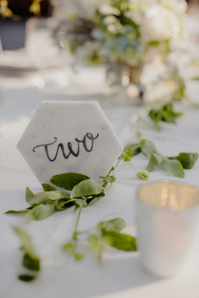 Jaclyn Watson Events • Modern Lakefront Wedding• Marble tabletop numbers
